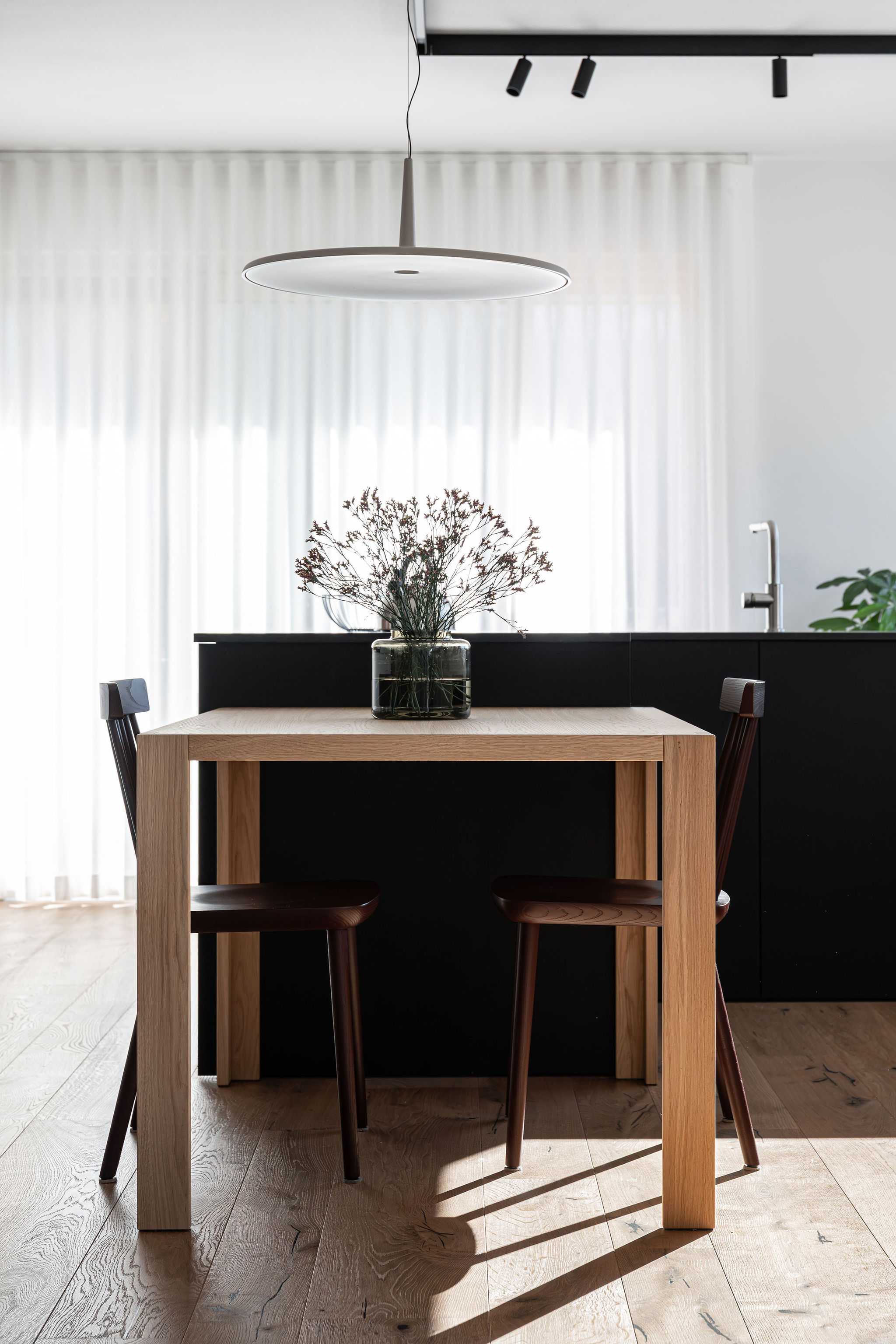 Cucina su misura minimale con isola a L nera, realizzata da Corazzolla